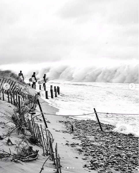 Instagram image of surfers with boards looking at waves