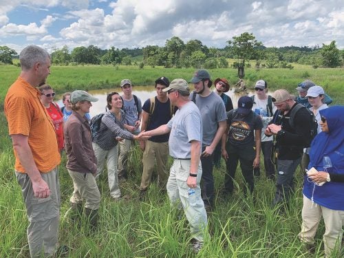 David Dooley greets researchers in the field in Indonesia