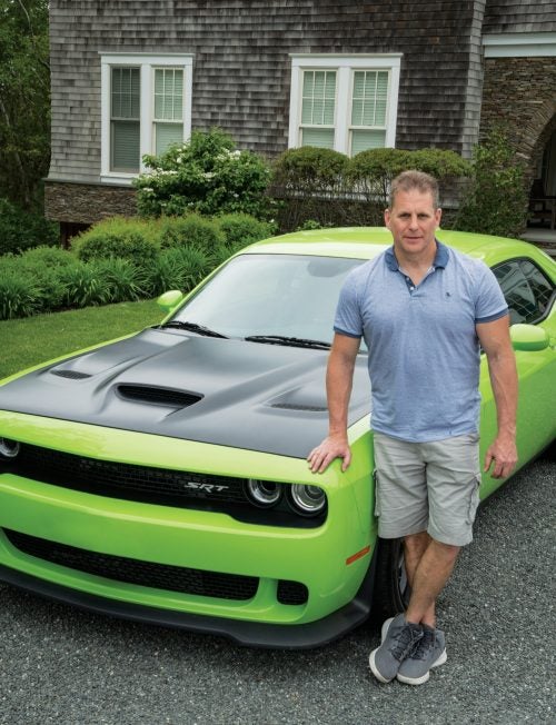 William Eigen standing in front of a green muscle car