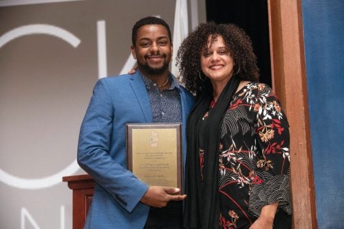 Gyasi Alexander with mentor Michelle Fontes '96, M.A. '11, CELS assistant dean of diversity, recruitment, and retention, who presented him with the William Gould Award for All-Around Outstanding Achievement at URI's 2019 Black Scholar Awards.