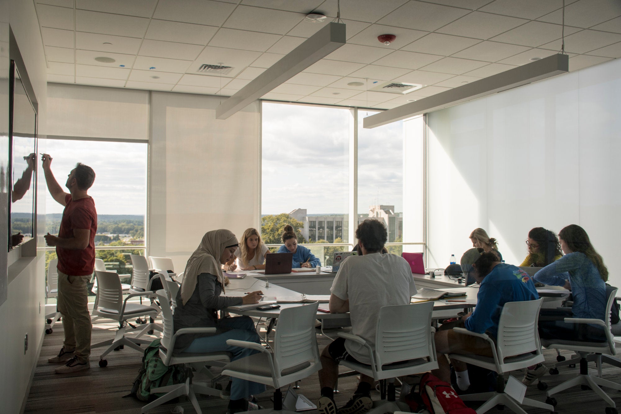 Students and their professor gathered for class in the new engineering facility