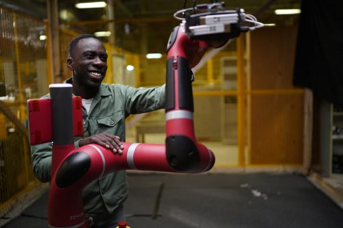 Nathan Ankomah-Mensah working with a robotic arm