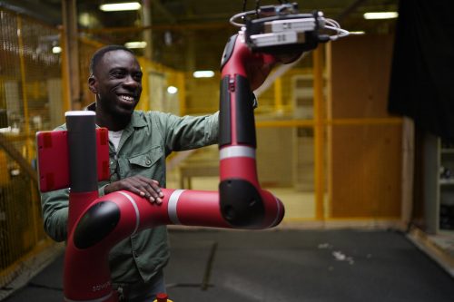 Nathan Ankomah-Mensah working with a robotic arm