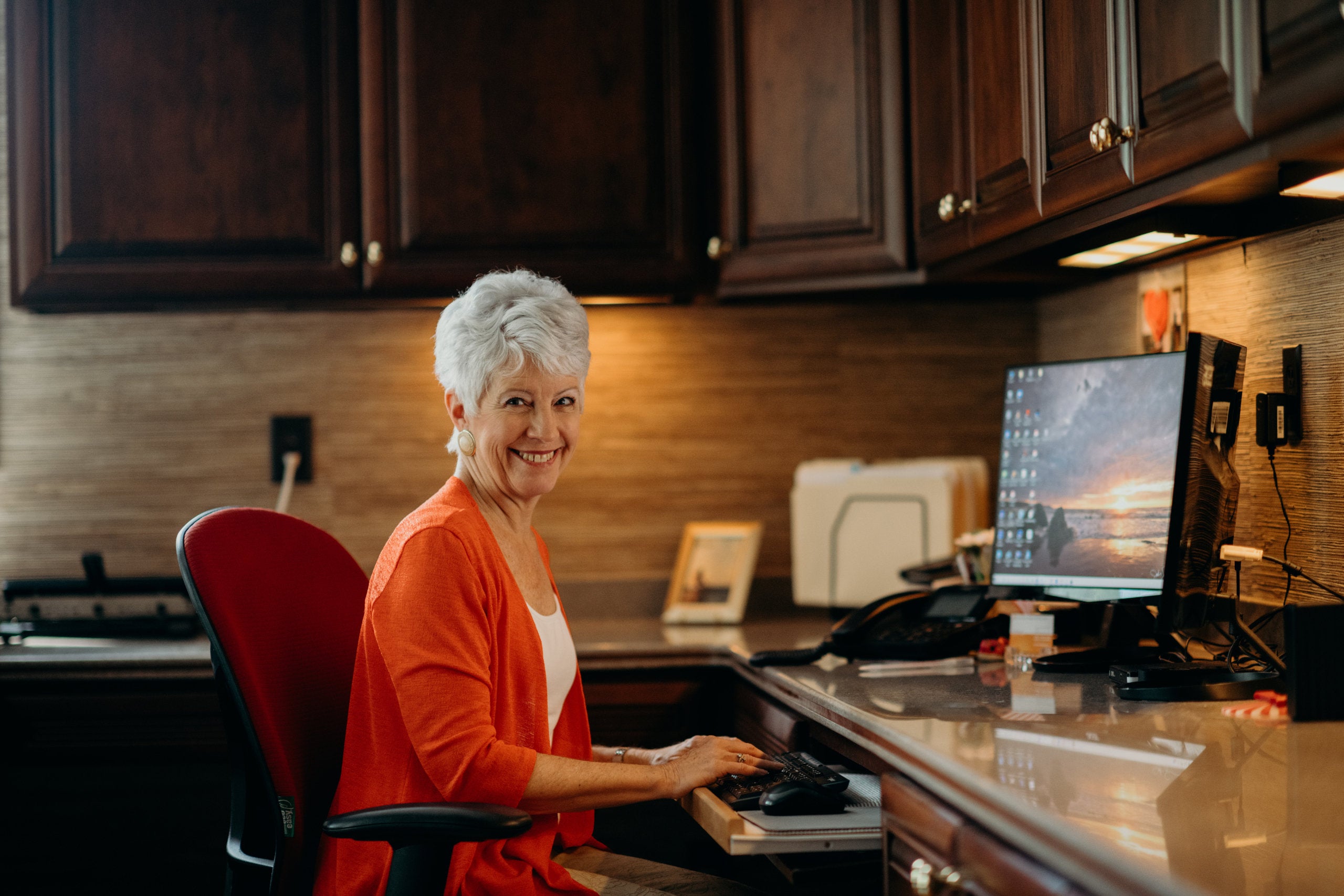 A woman working at her kitchen office