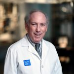 Jeffrey Ross dressed in a lab coat