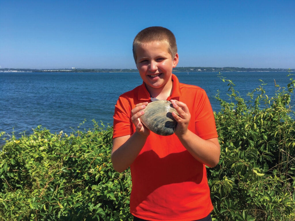 Cooper Monaco poses with the giant quahog he found last summer.