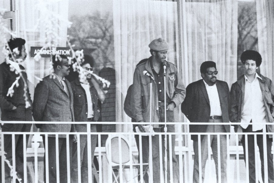 A group of Black student activists standing on the second floor balcony of the Carlotti Administrative Building