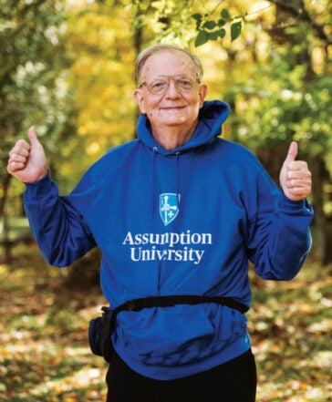 Library alum Larry Spongberg wearing an Assumption University sweatshirt