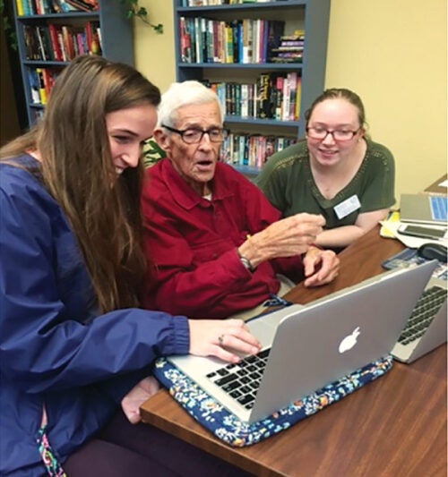 Left to right, Kristen St. Jean, M.B.A. ’20, Pharm.D. ’20; OLLI member Prentice Stout; and Amanda Loomis, Pharm.D. ’20, shared and learned about technology during a 2016 session of the URI Engaging Generations: Cyber-Seniors program at OLLI.