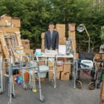 URI MBA student Thomas Bonneau started a nonprofit, America’s Recoverable Medical Supply (ARMS), which collects and repurposes medical supplies. He is pictured here surrounded by donated supplies.