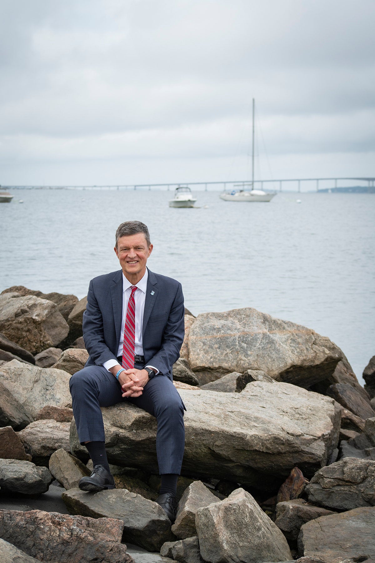 URI President Marc Parlange sitting at the shore of the university's Bay Campus