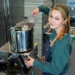 Ella Schneider working on her award-winning Gansett Craft Chocolate at Town Made shared kitchens in Wakefield, R.I.