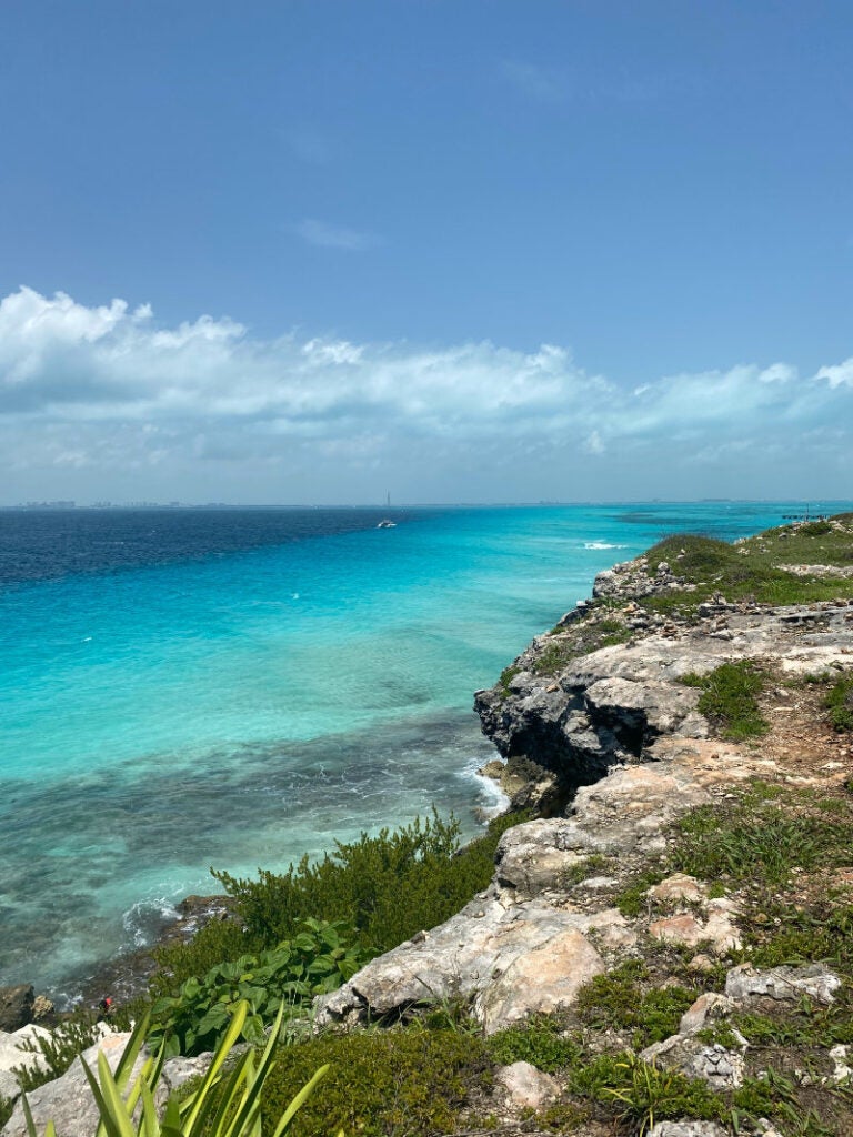 Vivid green-blue water, from a rocky coastal vantage point