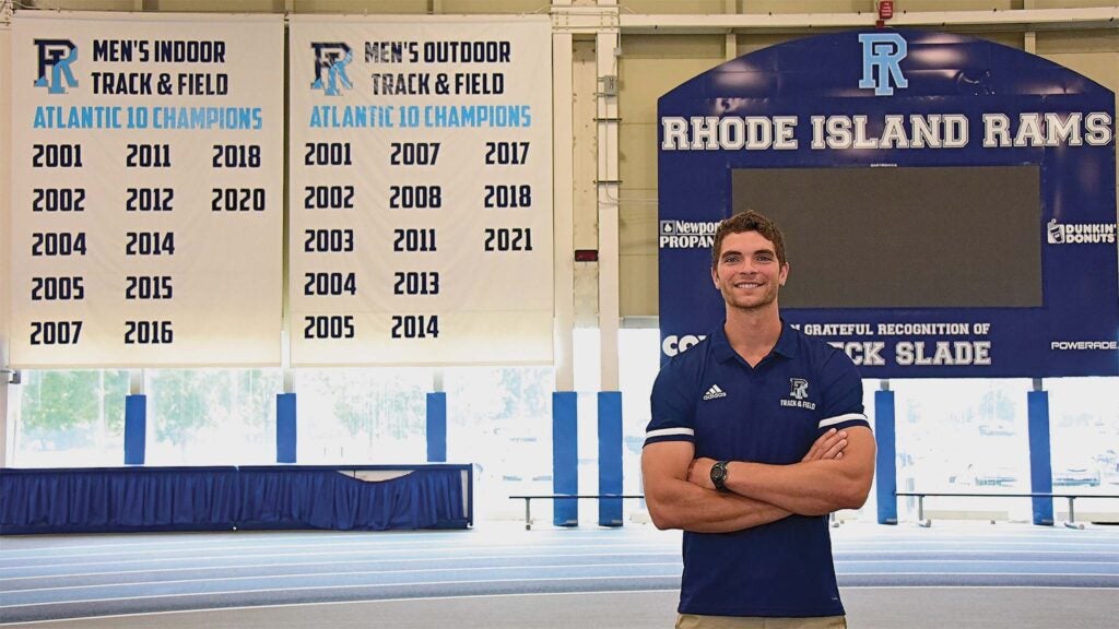 Trent Baltzell poses in front of the track in Mackal Field House