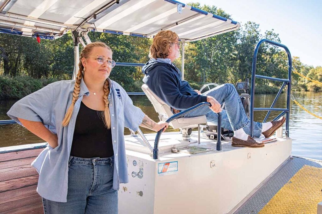 Samantha Jackson '22, Director of education for the Blackstone Valley Tourism Council and Captain Joe Walkden, M.S.'98 on the Blackstone Valley Explorer Riverboat