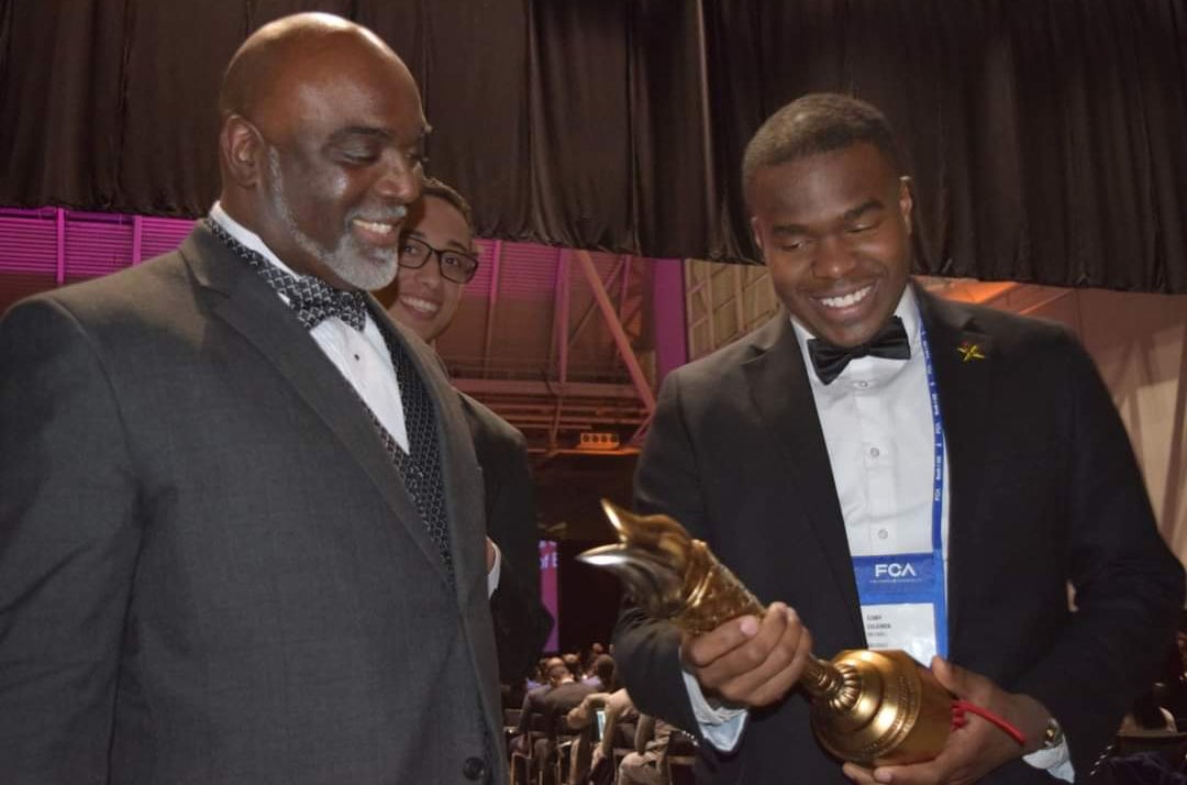Kenny Sulaimon (right) admires the award won by Charles Watson