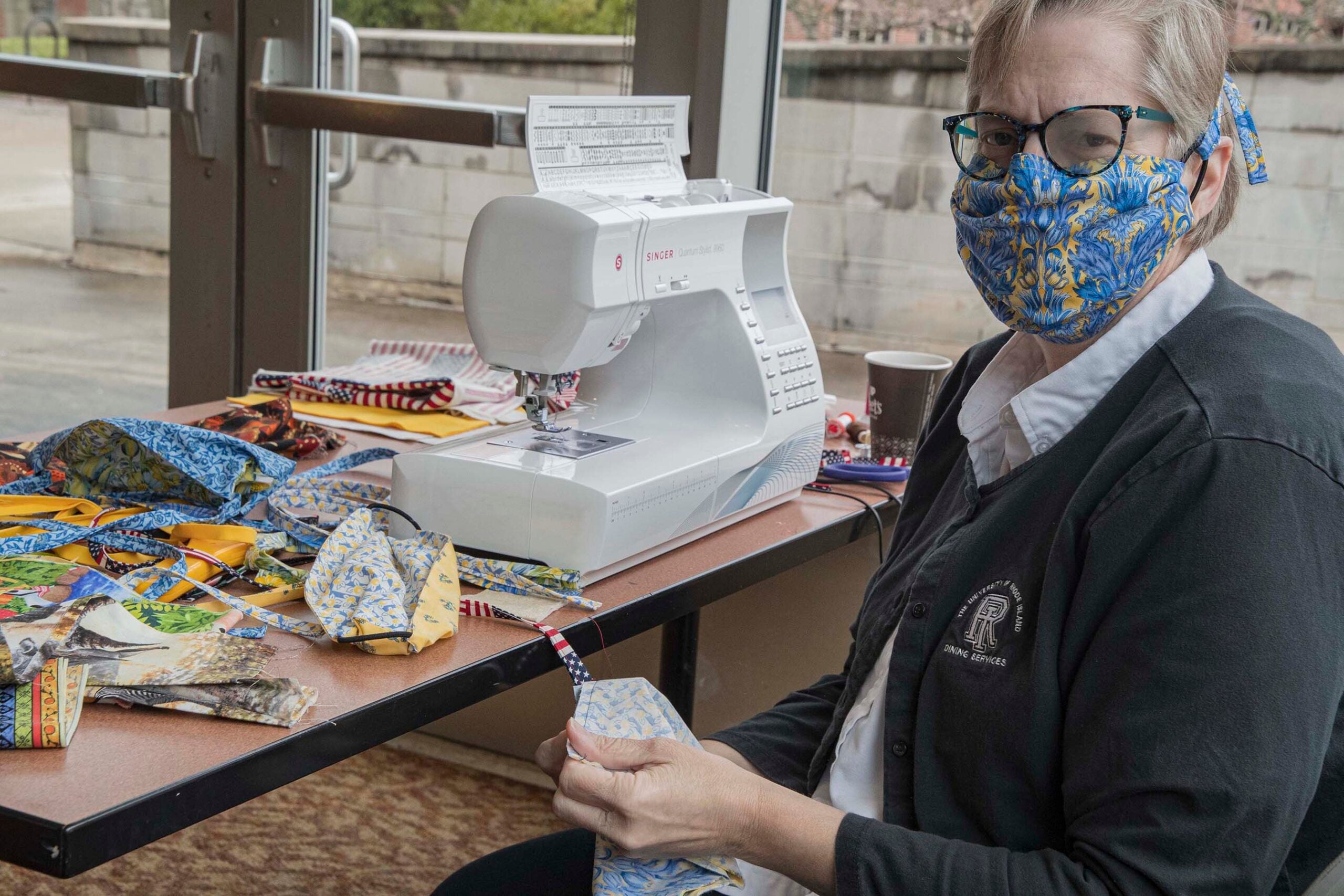 Diana Bibeault displays numerous, colorful masks that she is making