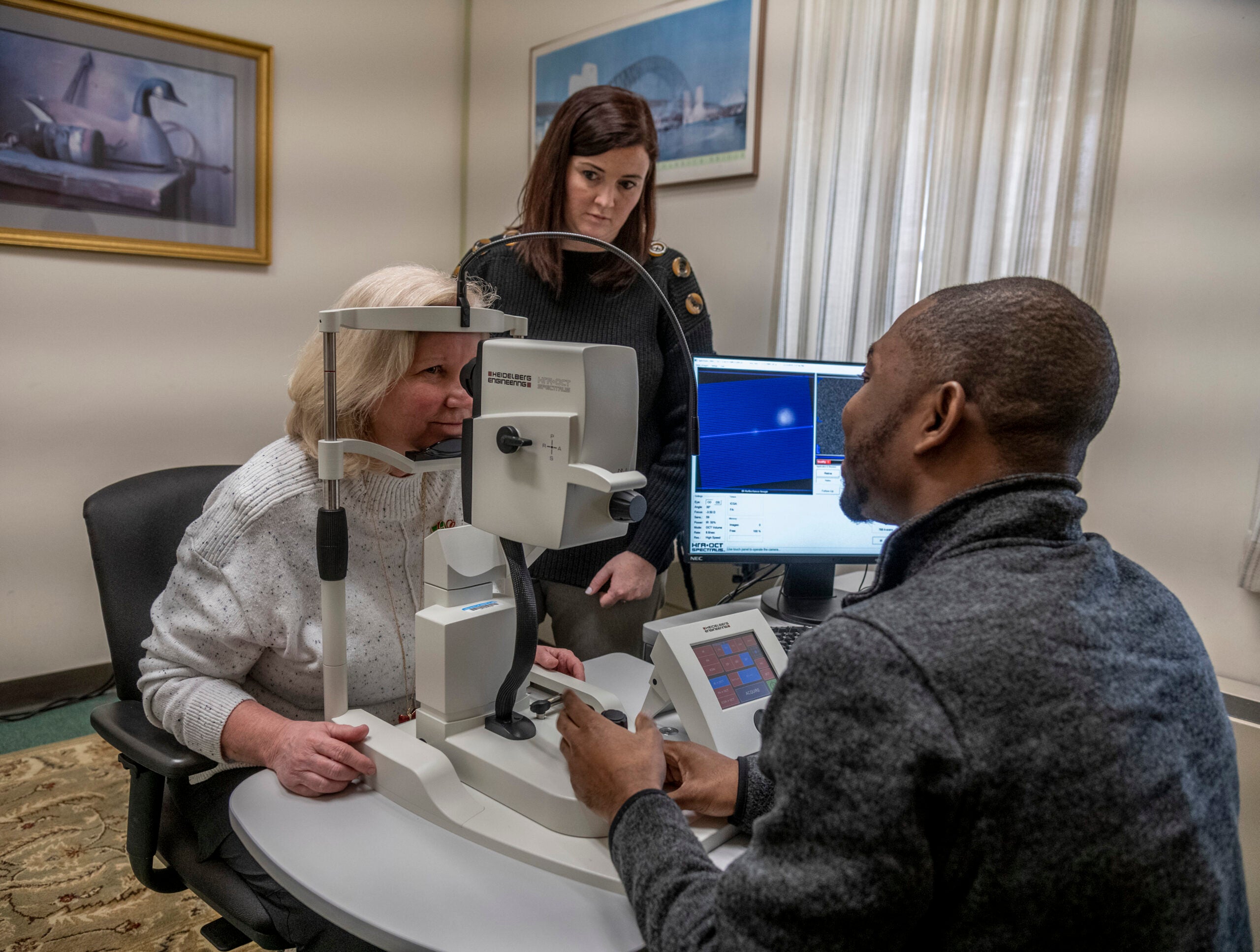 Team members setting up retinal scans