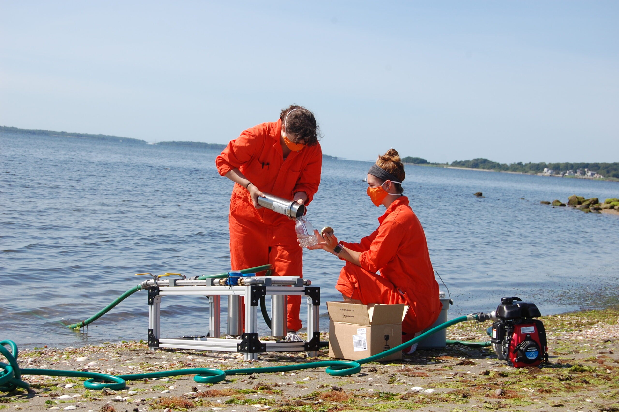 URI students Jacqui Roush (left) and Cara Megill collect samples
