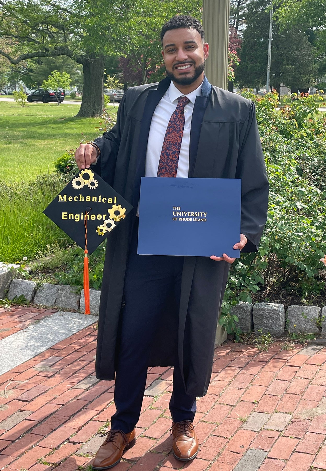 Jeancarlos Nolasco proudly displays his diploma