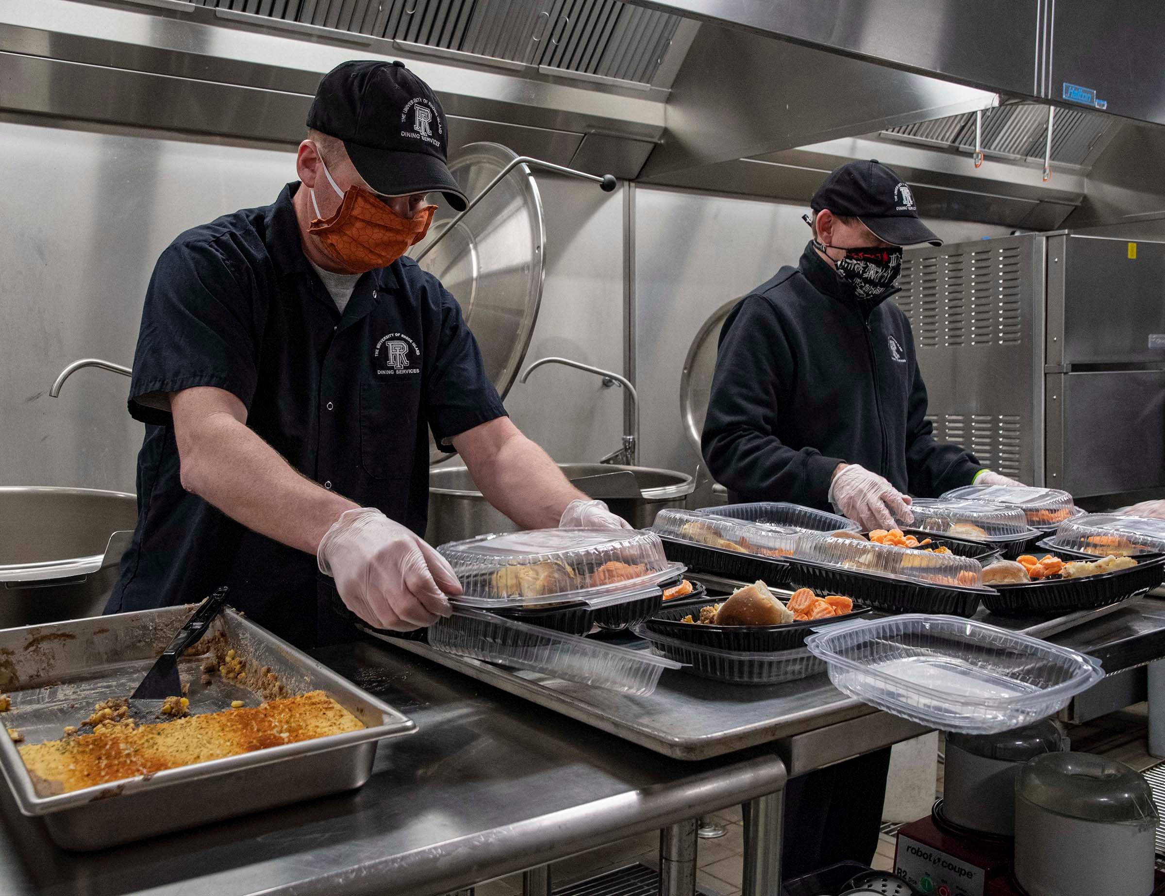 Kevin O'Brien, at left, and cook's helper John Fonseca, prepare shepherd's pie meals for delivery