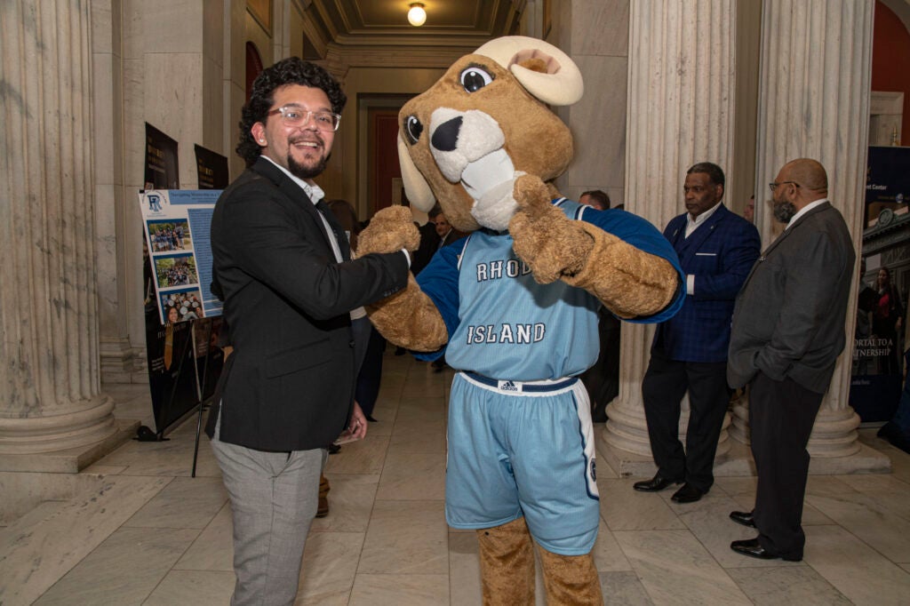 URI mascot Rhody the Ram poses with one of the speakers at URI Day
