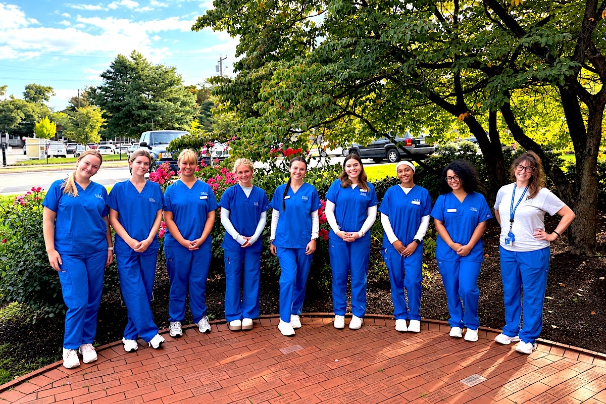 Eight URI nursing students who are working with hospice patients through partnership with HopeHealth in Providence