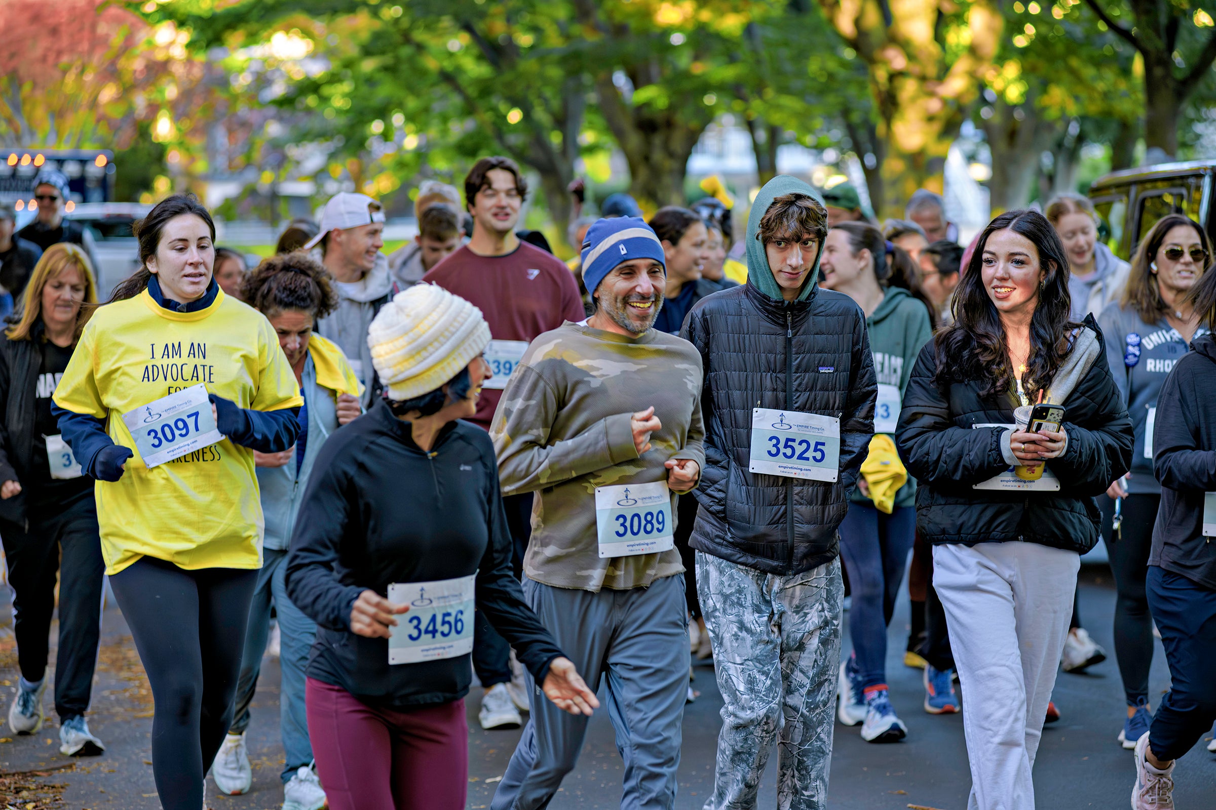 Participants with bibs walk and run in a group