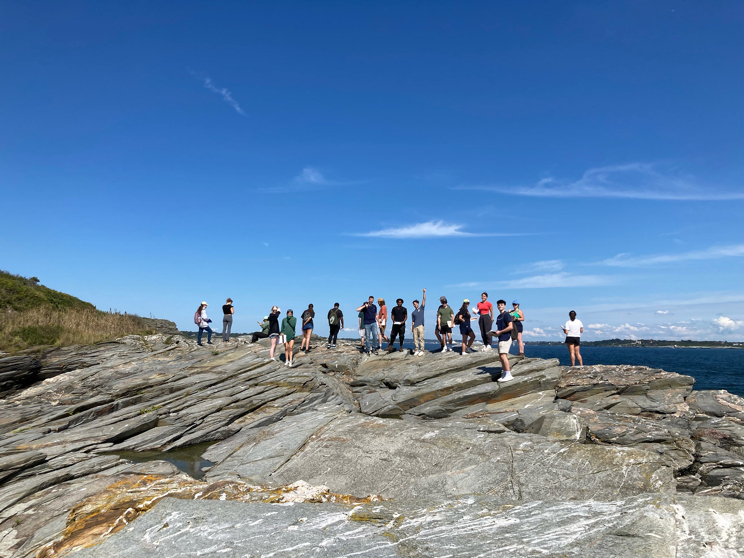 Group of geology students standing on rock at Beavertail State Park