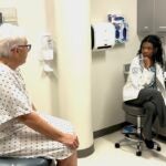 student Kai Reddie interviews a simulated patient