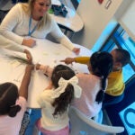 Toni Clifford M’26 at Garden City School in Cranston with students