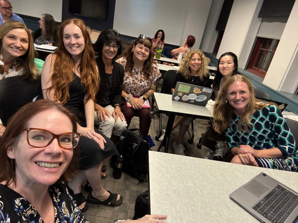 Nicole King and Laura Hamman-Ortiz (front) in URI’s Feinstein College of Education, with other members of the TRANSFORM team