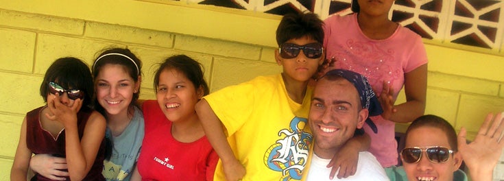 URI alumnus Matt Brum '10 with orphan children in Nicaragua