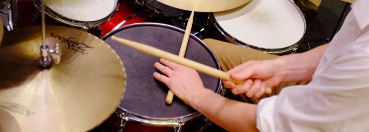 Drummer's hands playing on a set of drums