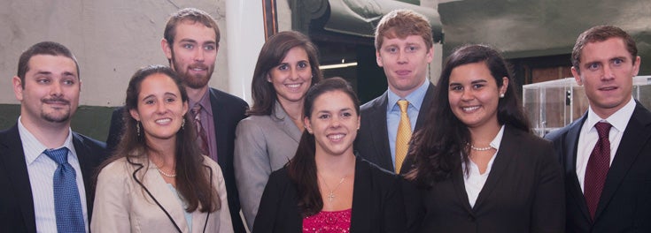 Headline: Change the shape of ships to come. Pictured: 8 URI engineering alumni hired by Navatek Ltd.