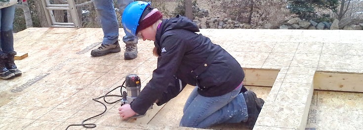 URI student working on a Habitat for Humanity home