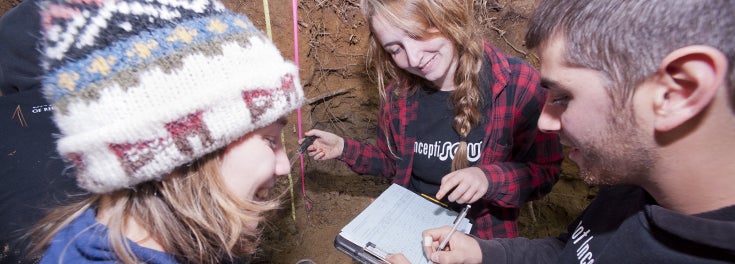 URI students engaged in soil testing