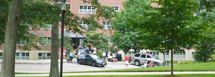 Cars unloading in front of residence hall.