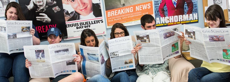 Student newspaper staff reading the latest issue of the Cigar