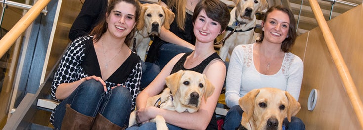 Students with the service dogs they are training