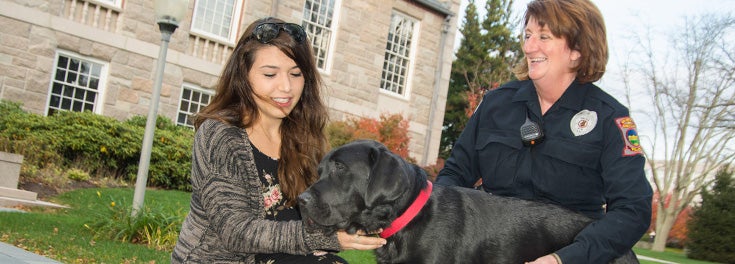 Sgt. Vieira and Figaro with a student