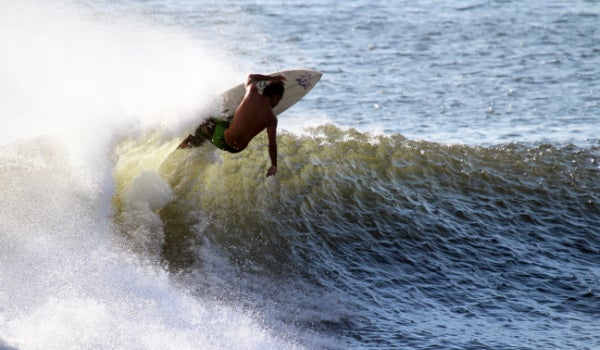 A surfer enjoys the waves.