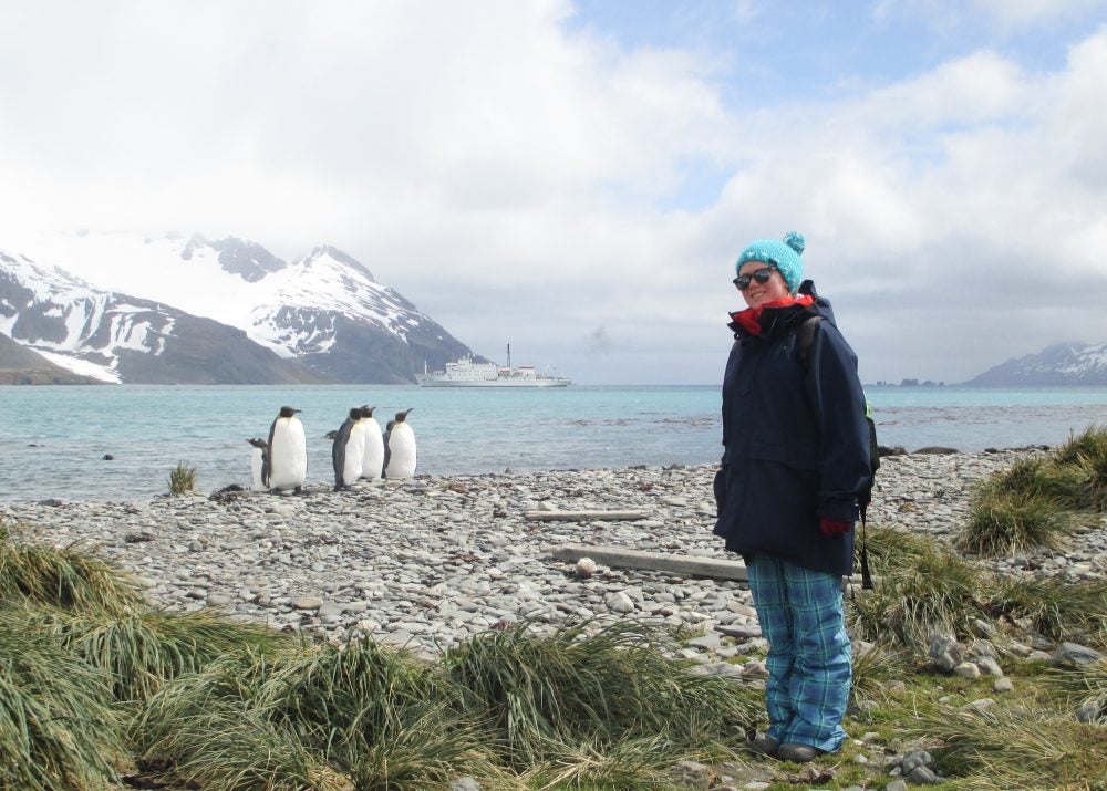 Breezy Grenier in Antartica with penguins