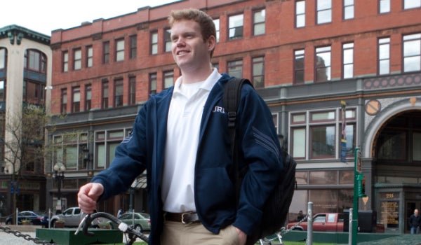 A student walking in front of the URI Providence Campus, College of Education and Professional Studies