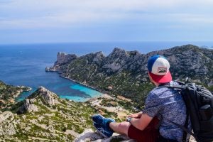URI student overlooking the rocky inlets of the Mediterranean Sea
