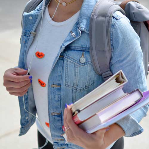 student with backpack and books