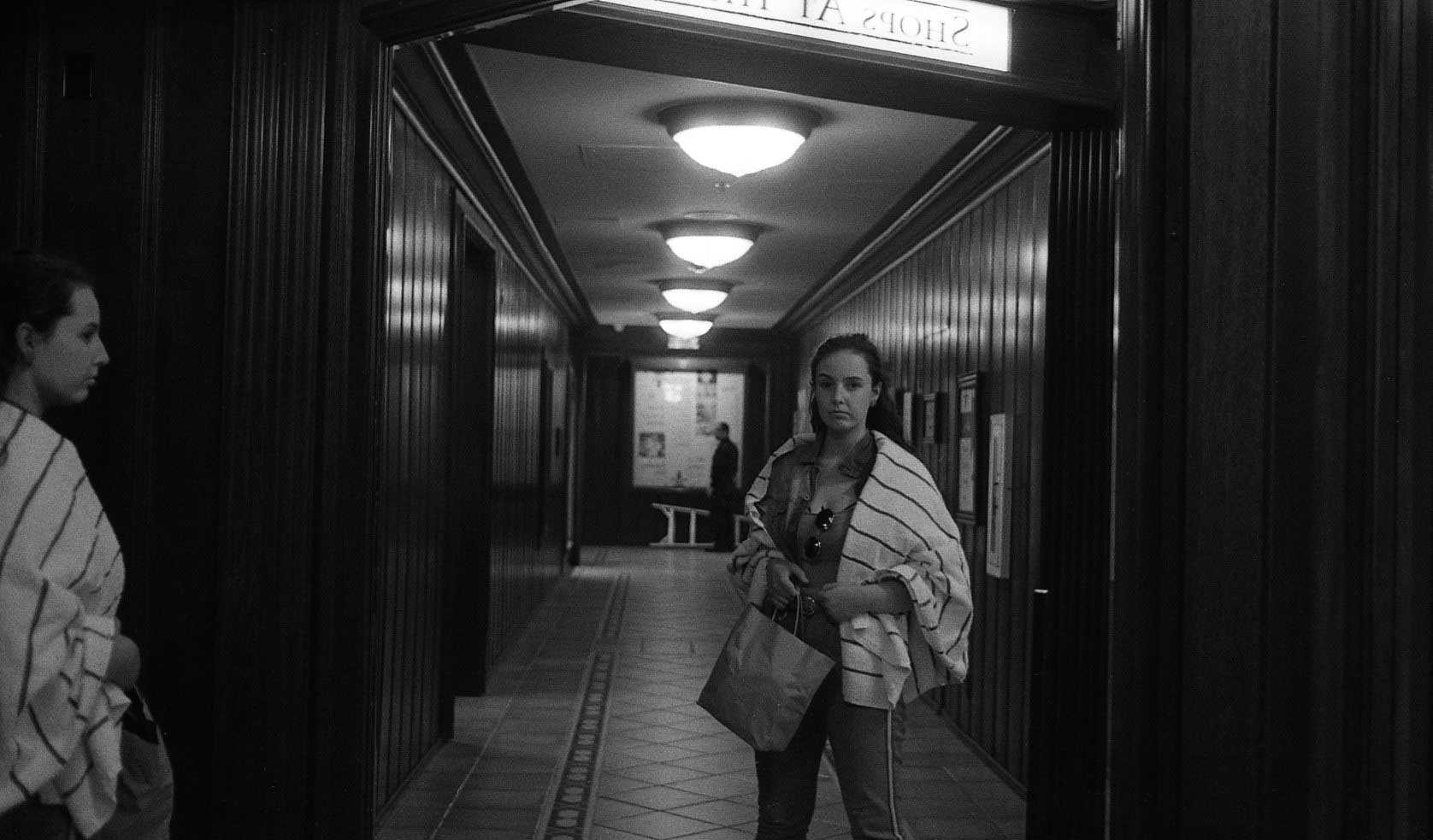 Woman in a hallway looking at the her reflection