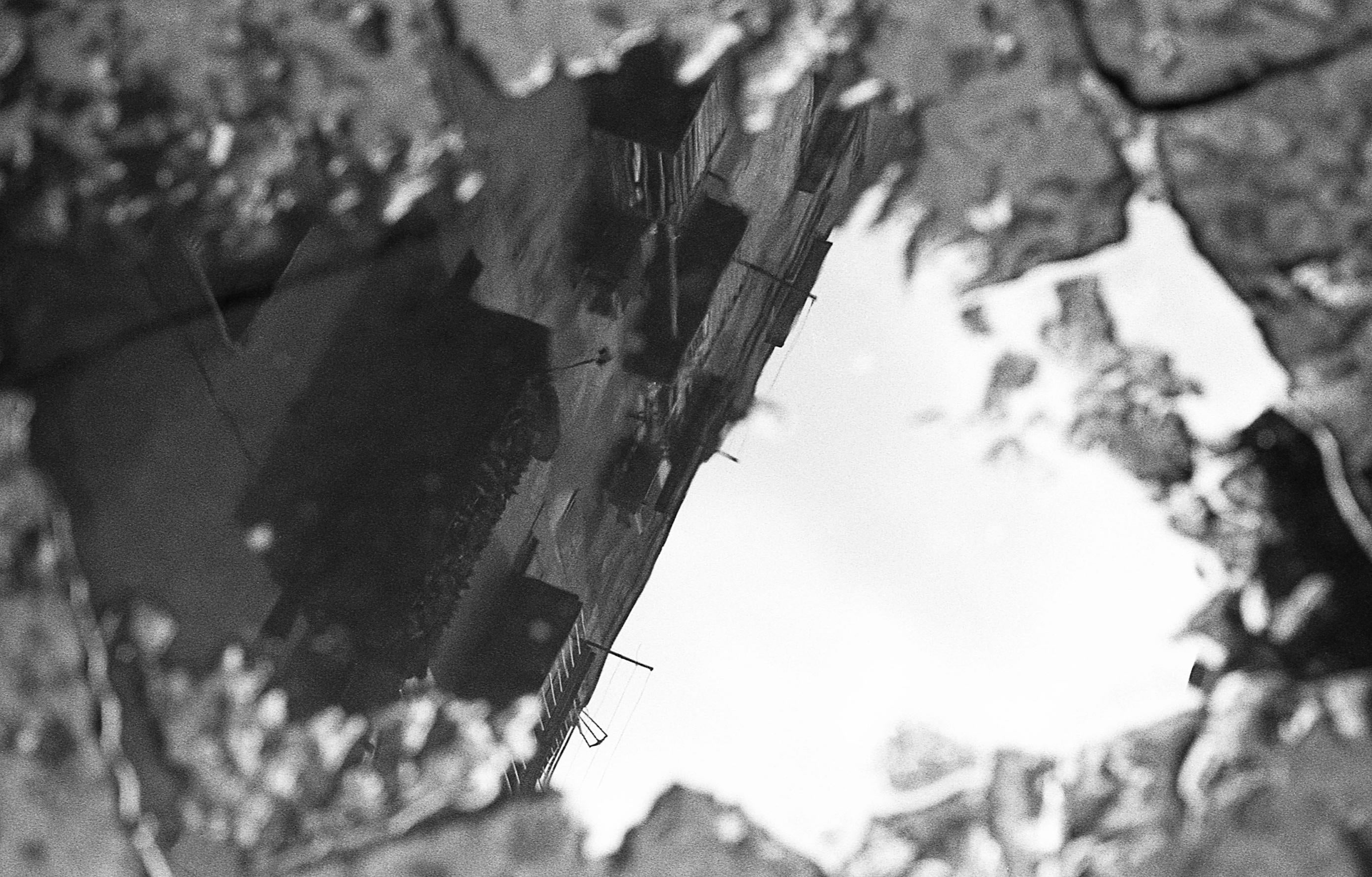 Reflection of buildings in a street puddle