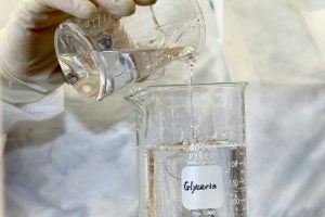 A pharmacist measures glycerin on a scale