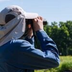 Coastal fellows student looking through binoculars